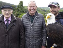 Symbolhafter hätte es nicht sein können - der Adler als Wappentier für Stärke als Kulisse für die Ehrung langjähriger Mitgliedschaft in einer starken Gemeinschaft: Albert Marx (li), Klaus Böttcher und Falkner Benjamin Aschmann mit einem Weißkopfseeadler. Foto: KERH Herrenwald/Schwalm