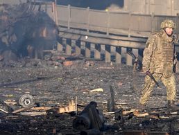 Ein ukrainischer Soldat in Kiew, im Hintergrund das verkohlte Wrack eines Militärfahrzeugs. In der Nacht ist in der ukrainischen Hauptstadt zu schweren Gefechten gekommen. Nach ukrainischen Angaben ist die Lage unter Kontrolle. Foto: picture alliance / ASSOCIATED PRESS / Efrem Lukatsky