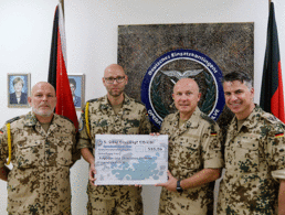 Die Spieße und der Kontingentführer übergeben den Spendencheck an den Initiator der Sammlung. Foto: Bundeswehr/Jan.B.