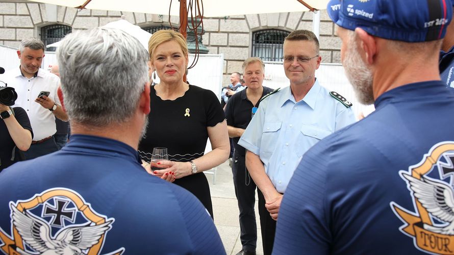 Julia Klöckner, Bundestagspräsidentin und Schirmfrau des Veteranentages, und Oberst André Wüstner im Gespräch mit Veteranen der "Tour of Valor", die auf dem Rad von Bayern nach Berlin zum Veteranentag gereist sind. Foto: DBwV/Yann Bombeke