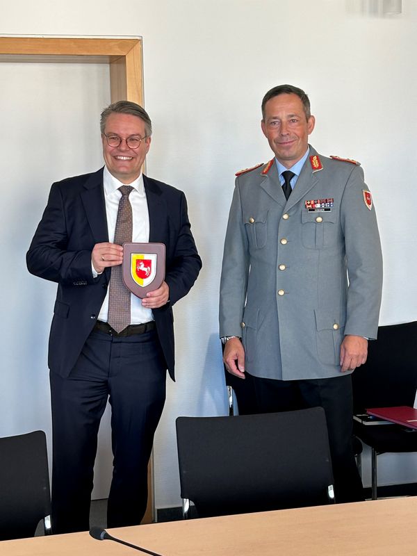 Generalmajor Hübner übergibt das Wappen der 1. Panzerdivision an Staatsminister Tobias Lindner. „Politische Bildung ist Aufgabe aller Disziplinarvorsitzenden – also auch meine”, so der Divisionskommandeur. „Mein Dank gilt dem Bildungswerk.” Foto: DBwV/Oliver Krause