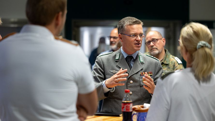 Im Dialog: Bei Kaffee und Snacks hatten die Mitarbeiterinnen und Mitarbeiter des Bundeswehrzentralkrankenhauses Koblenz die Möglichkeit, mit dem Bundesvorsitzenden Oberst André Wüstner ins Gespräch zu kommen. Foto: DBwV/Yann Bombeke