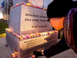 Ein Schüler legt eine Kerze am Denkmal ab, das im belgischen Mesen an den Weihnachtsfrieden von 1914 erinnert. Foto: picture alliance/AP Photo/Virginia Mayo