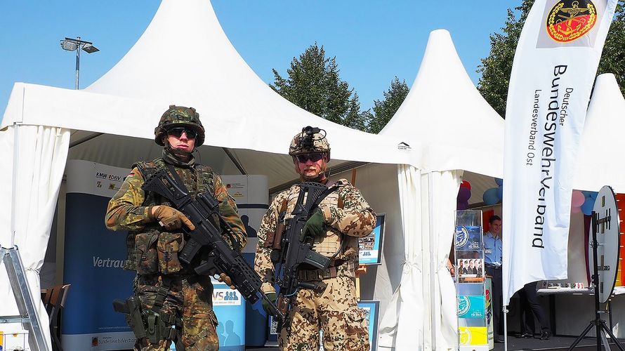 Ein Soldat des Seebataillons (l.) und en Soldat mit der Ausrüstung "Infanterist der Zukunft" stehen vor dem Stand des DBwV. Foto: DBwV/Kruse