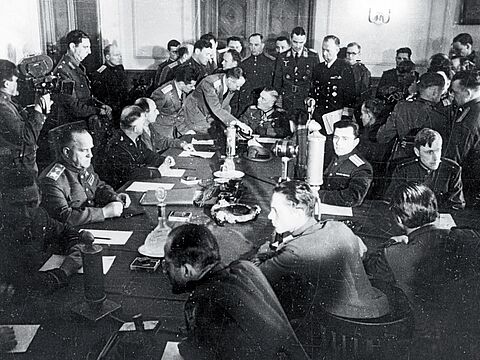 Blick in den Raum während der Unterzeichnung der Kapitulation in Berlin-Karlshorst. Links am Tisch der sowjetische Marschall Georgi Schukow, am Kopfende Generalfeldmarschall Wilhelm Keitel. Foto: dpa/Picture Alliance 