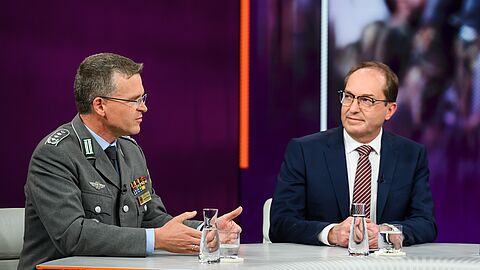 Der Bundesvorsitzende Oberst André Wüstner erklärt am Donnerstag in der politischen Talk-Show „Maybrit Illner“ im ZDF erneut, wie wichtig der personelle Aufwuchs für die Bundeswehr ist. Gast in der Sendung war auch Bundesinnenminister Alexander Dobrindt (CDU, rechts). Foto: ZDF/Jule Roehr